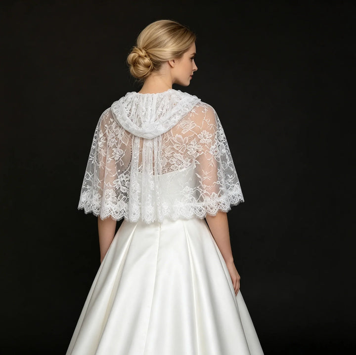 Off-white hooded lace bridal cape, back view with sheer floral lace and scalloped hem