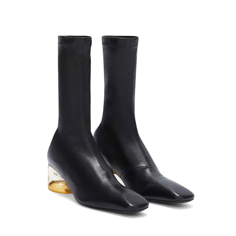 Black square-toe ankle boots with mid block heel and curved cutout detail