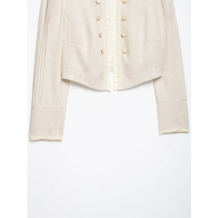 Beige cropped blazer hem with structured panel seams and long sleeves