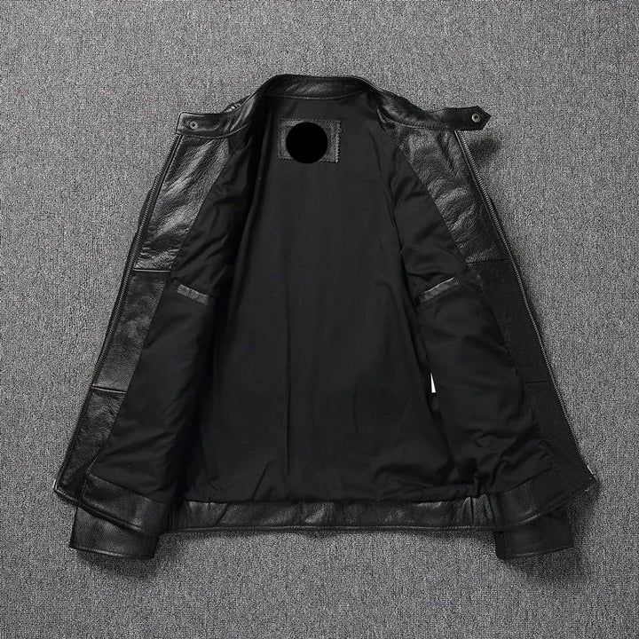 Black leather jacket with a brand label on a gray textured background