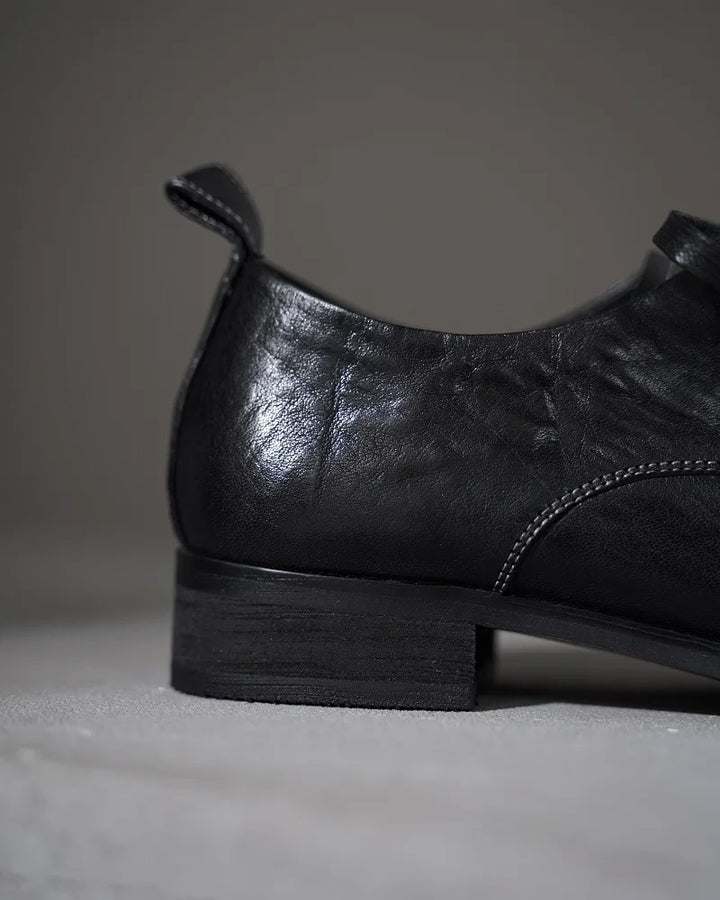 Black leather lace-up flat shoe heel and side seam detail