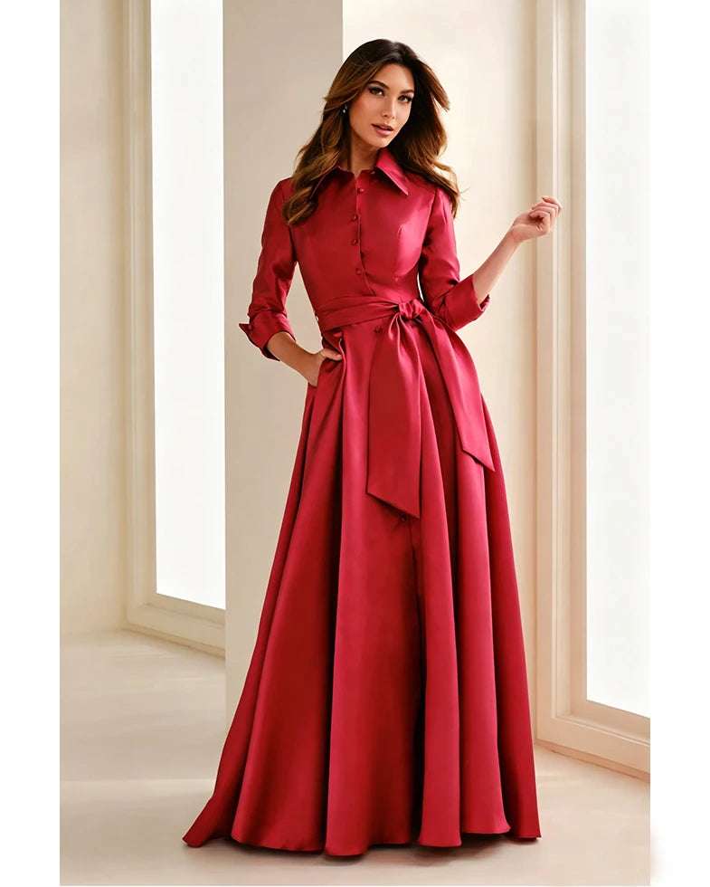 Red chiffon gown with button front, belted waist tie, long sleeves and full A-line skirt.