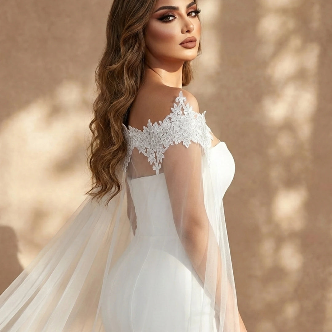 Off-white bridal gown with embroidered lace neckline and layered sheer veil