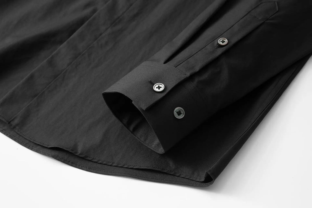 Black men’s slim-fit button-up shirt cuff with double buttons and clean hem