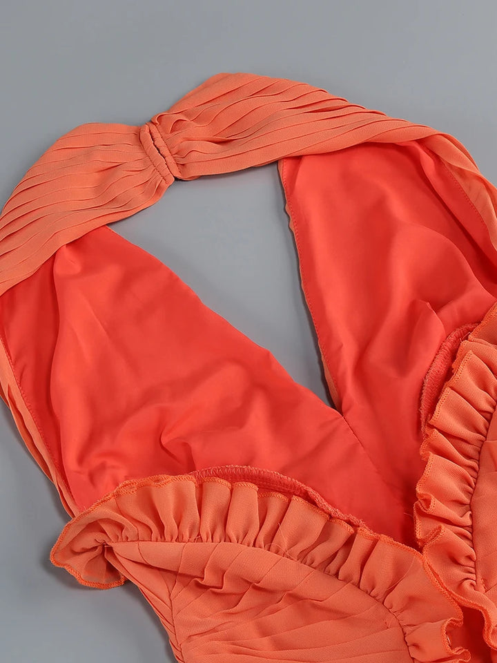 Orange A-line dress with halter neckline and layered ruffle trim