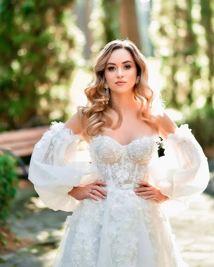 Ivory lace bridal gown with off-shoulder sleeves, sweetheart bodice, and textured 3D florals