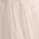 Beaded lace and mesh close-up on ivory bridal gown bodice