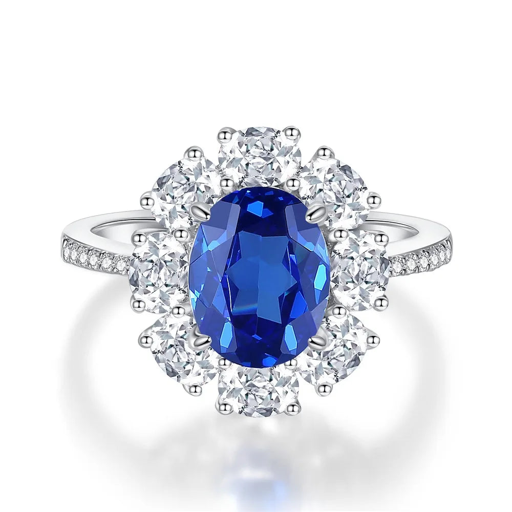 Diamond halo ring with oval deep blue center stone and round diamond accents