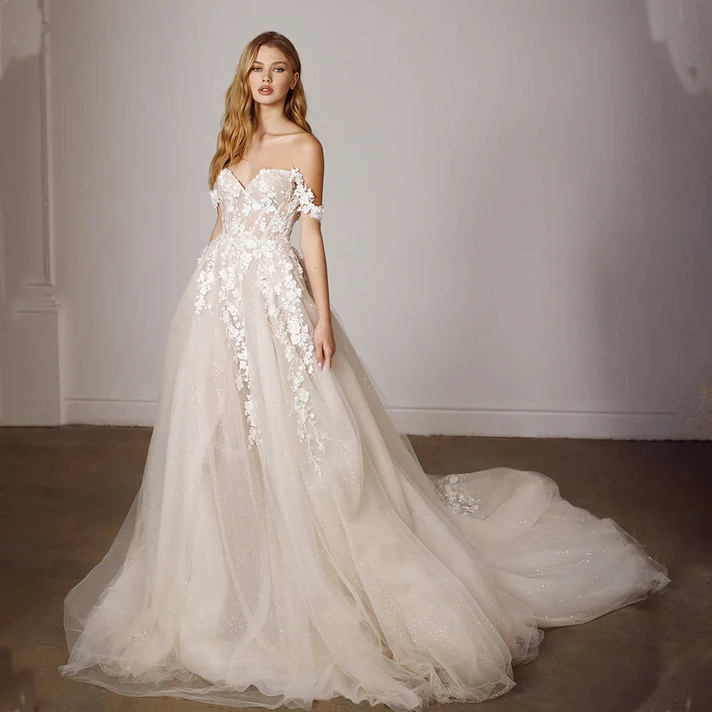 Off-shoulder lace bridal gown with sweetheart neckline and long tulle train
