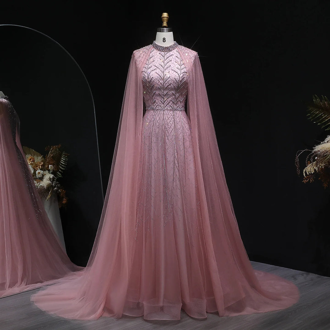 Pink evening gown with cape on a mannequin against a dark background