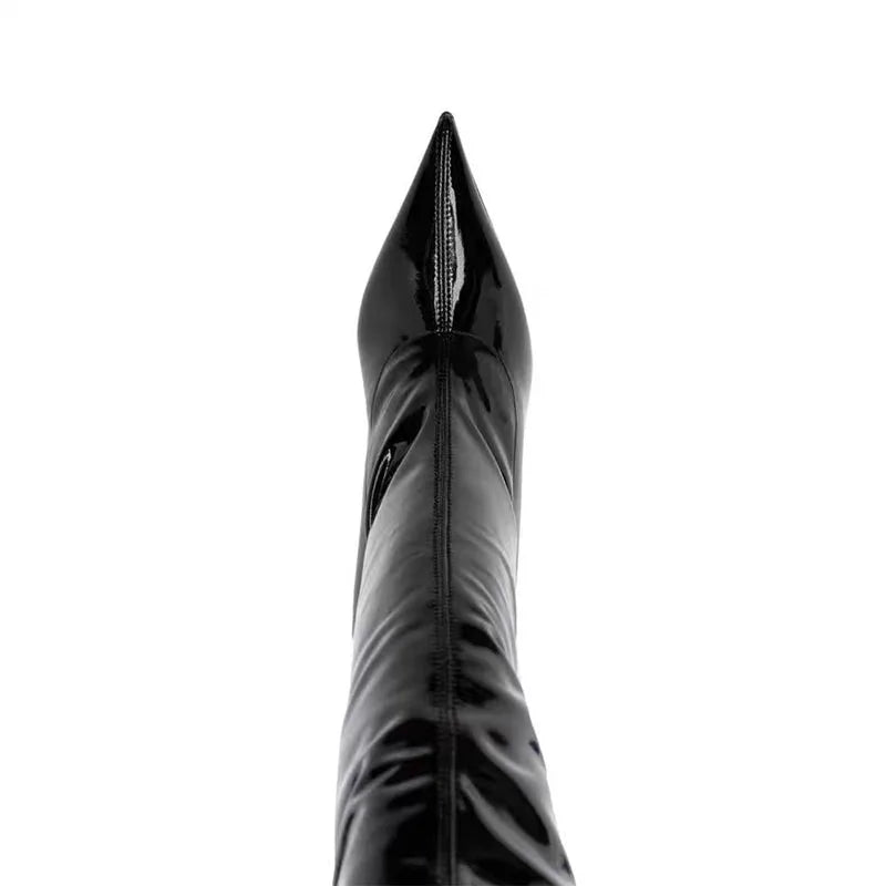 Black shiny patent leather boot upper with pointed toe and high stiletto heel.