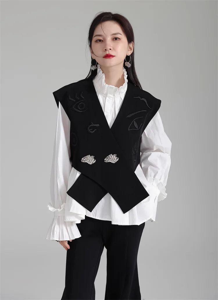 Black irregular women’s suit waistcoat, V-neck with embroidered accents and silver button pair.