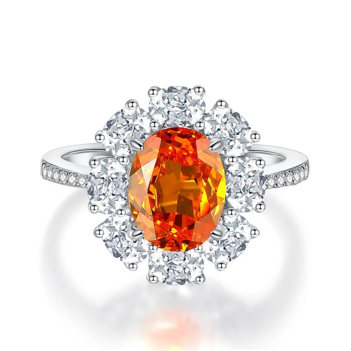 Diamond halo ring with oval orange center stone and round diamond accents