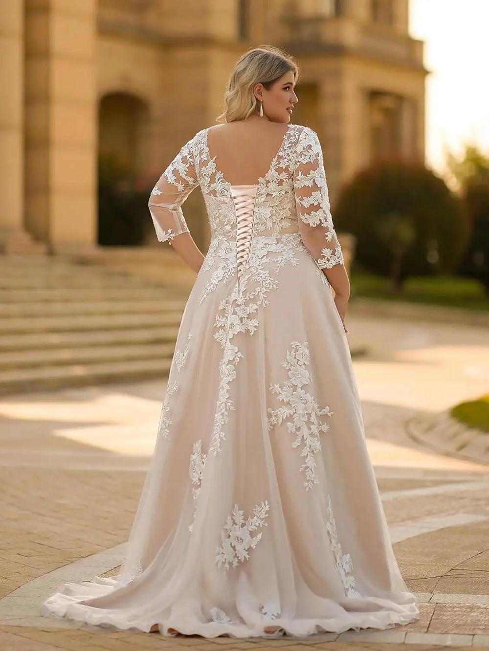 Ivory lace wedding dress with illusion 3/4 sleeves, lace appliques, and A-line skirt.