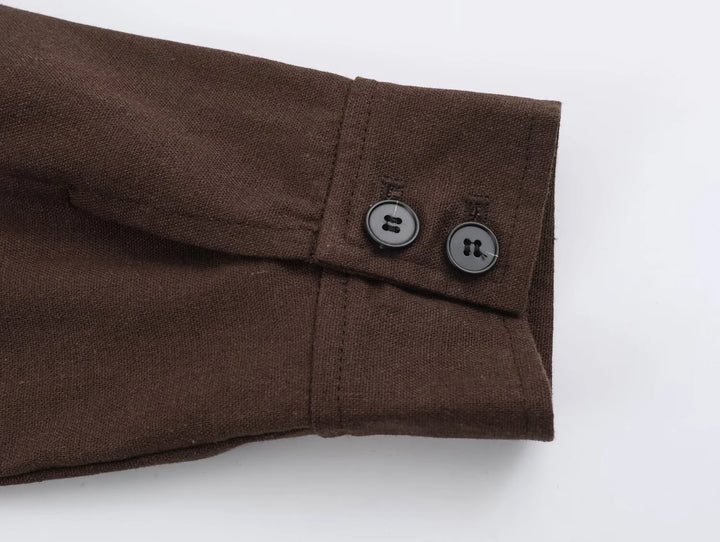 Dark brown coat sleeve cuff with two-button closure