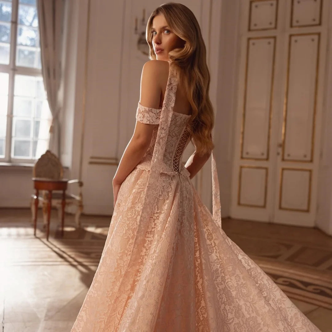 Champagne lace off-shoulder wedding gown, back/side view with long flowing skirt