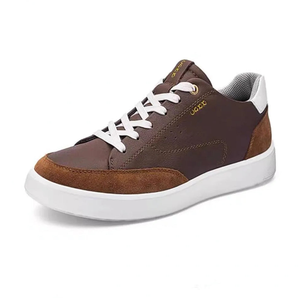 Brown sneaker with white laces on a white background, featuring the brand name &