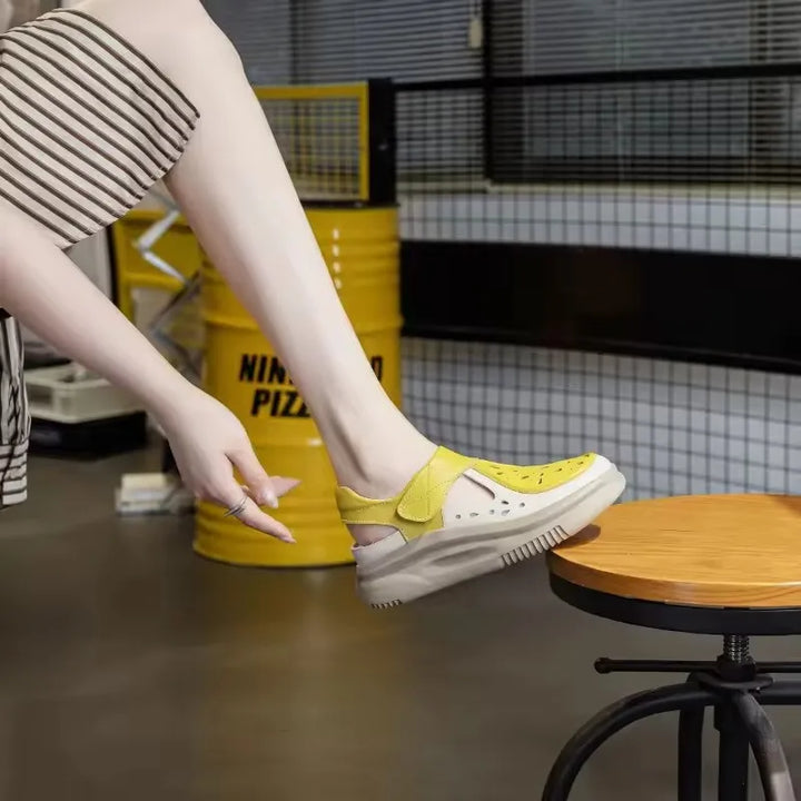 Yellow and white thick-sole leather sandals with hook-and-loop strap, close-up