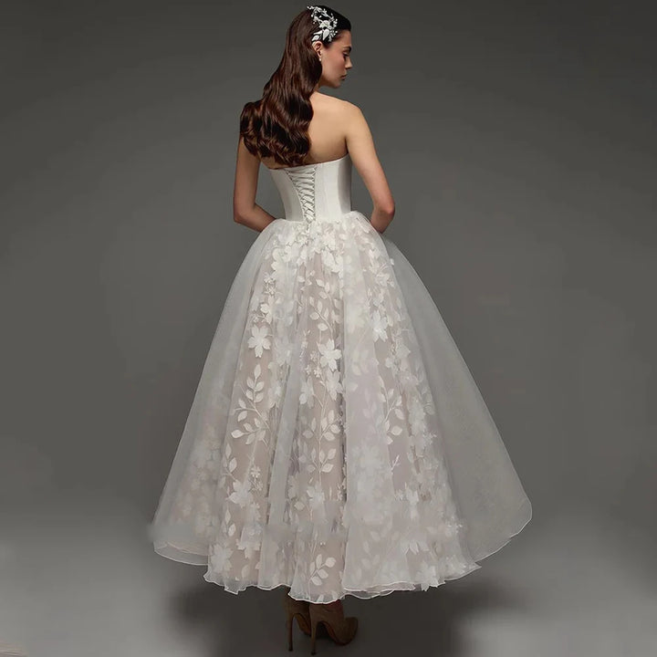 Strapless bridal gown back view with lace tulle skirt and satin bodice, full length