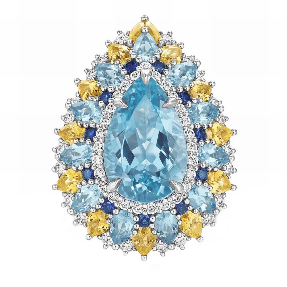 Oval aquamarine centerpiece cluster ring with blue and yellow halo stones in silver