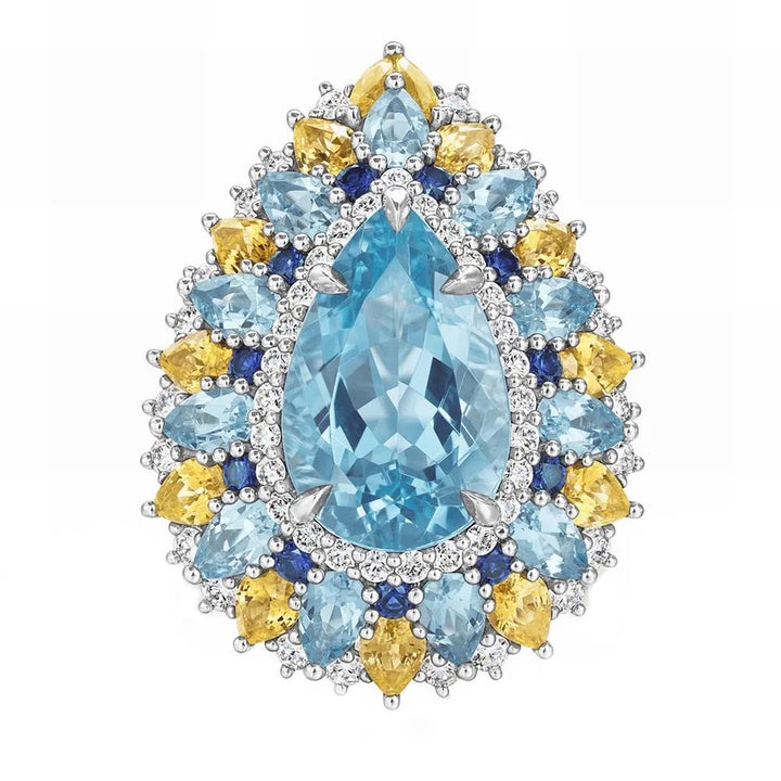 Oval aquamarine centerpiece cluster ring with blue and yellow halo stones in silver