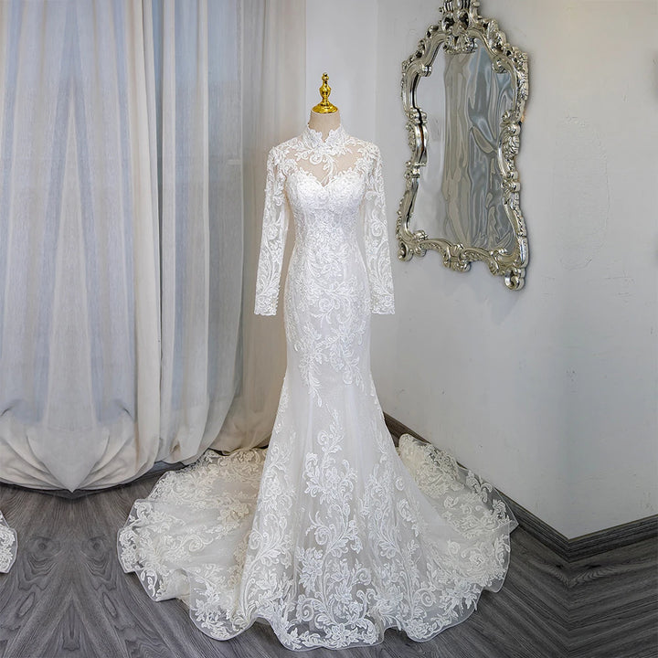 Ivory lace high-neck long-sleeve bridal gown with mermaid silhouette and flowing train