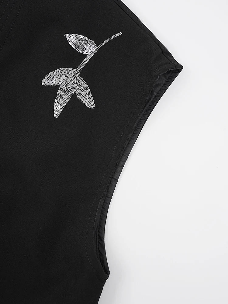 Black vest with silver sequin floral applique on the shoulder