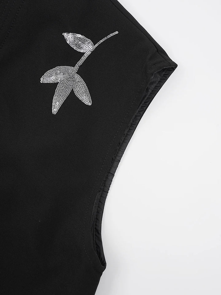 Black vest with silver sequin floral applique on the shoulder