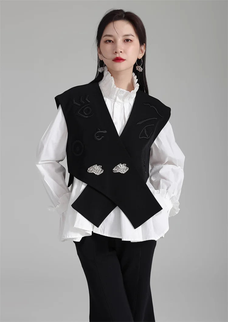 Black irregular women’s suit waistcoat with V-neck, embroidered details, and silver buttons.