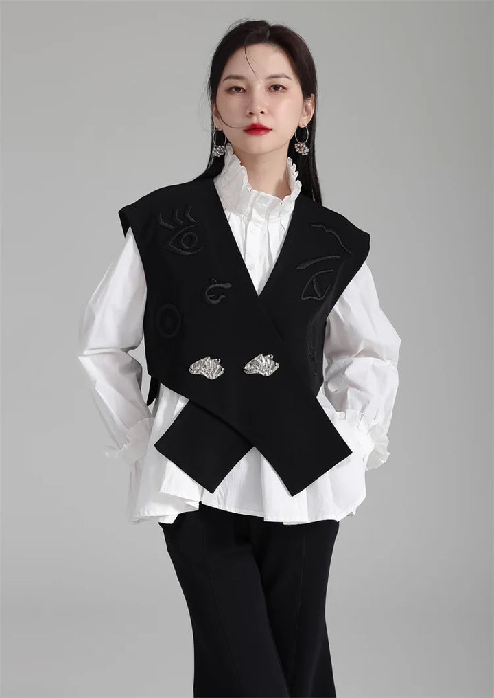 Black irregular women’s suit waistcoat with V-neck, embroidered details, and silver buttons.