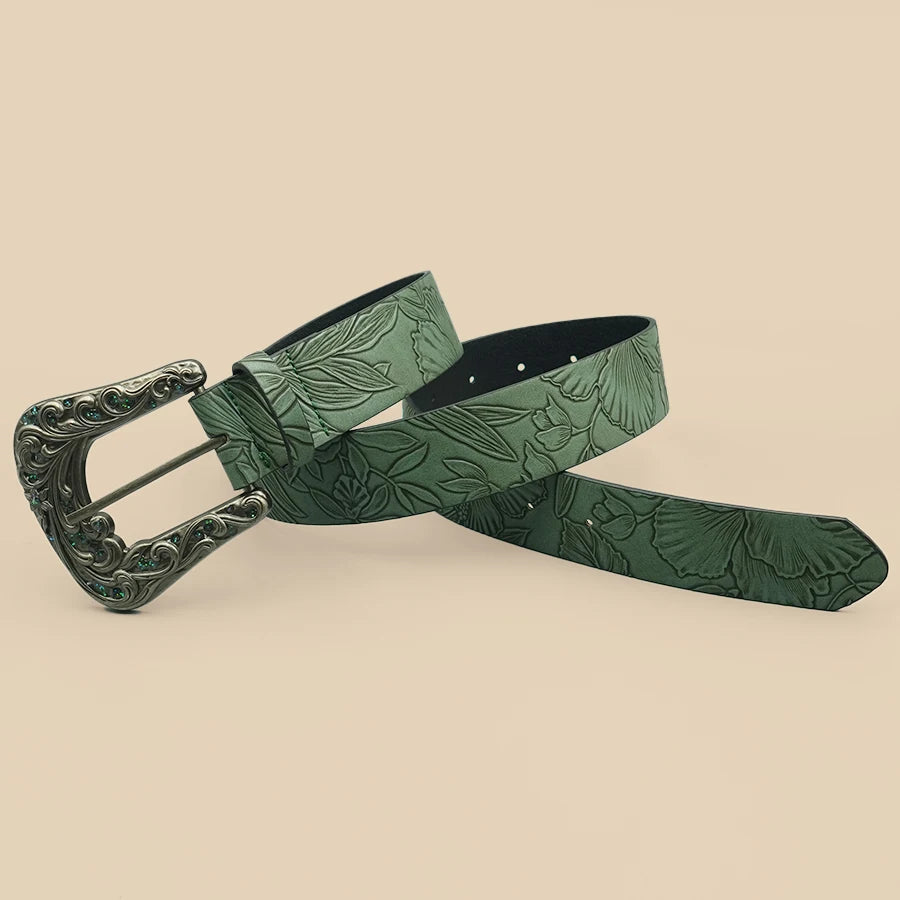Green leaf-embossed belt with ornate silver buckle and dark-lined end