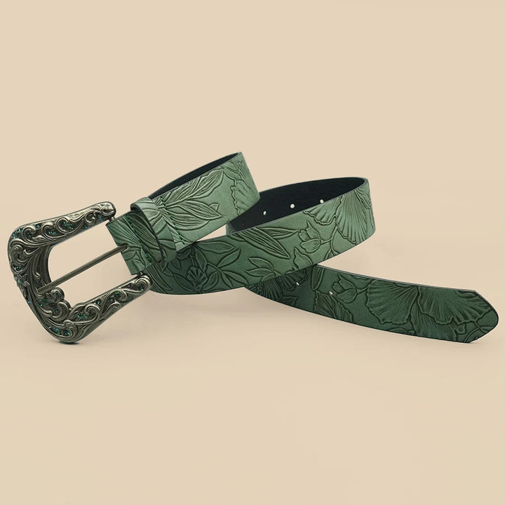 Green leaf-embossed belt with ornate silver buckle and dark-lined end