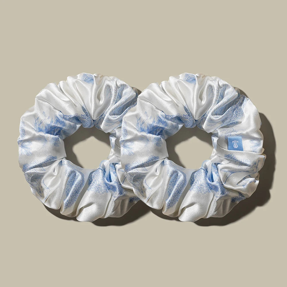 White satin ponytail hair band scrunchies with light blue accents and gathered elastic