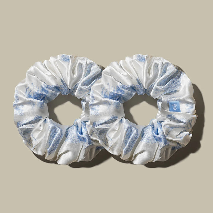 White satin ponytail hair band scrunchies with light blue accents and gathered elastic