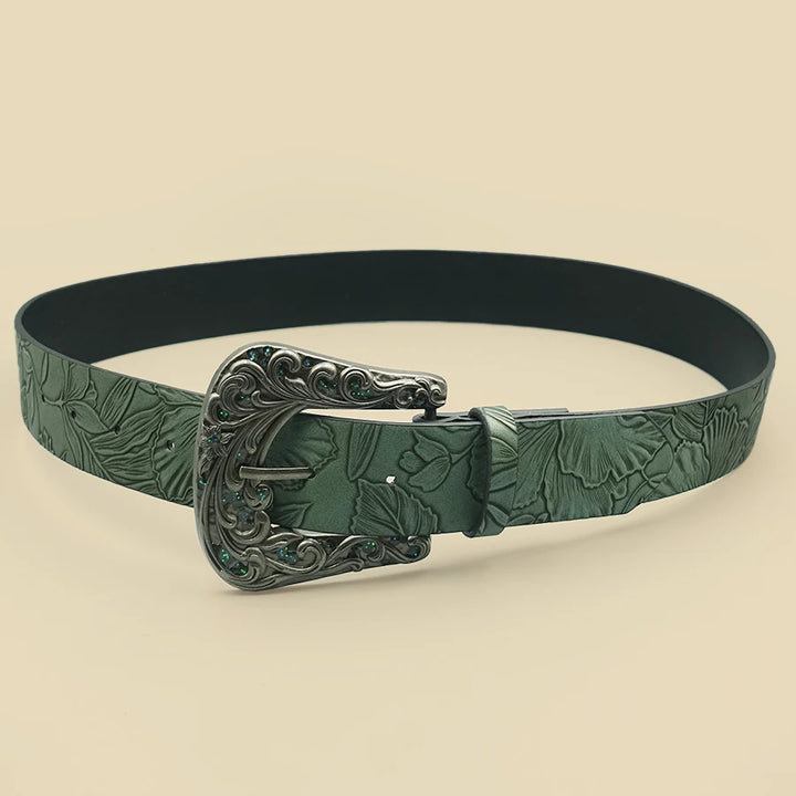 Leaf-patterned green belt with ornate silver buckle, flat lay