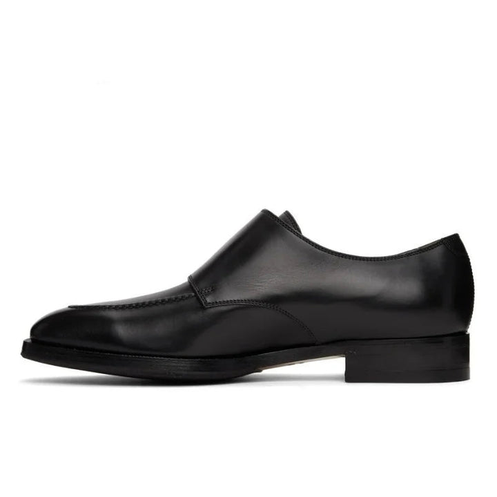 Black leather shoe on a white background with 'Stiglitz' branding.