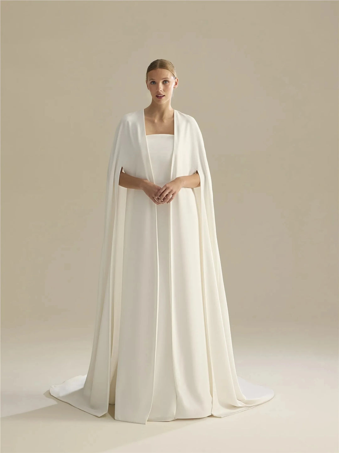 Off-white bridal cape with draped neckline and long train
