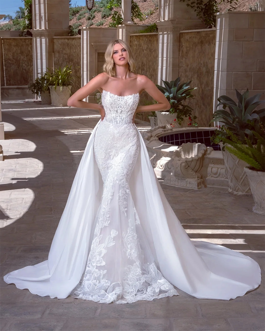 White strapless lace bridal gown with fitted bodice and full A-line skirt with appliques