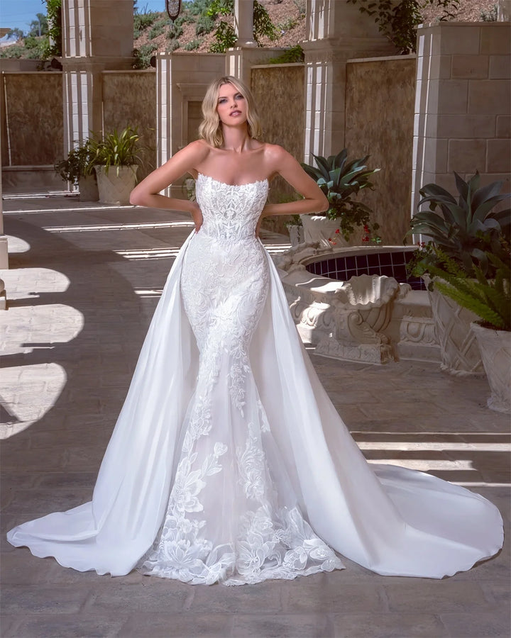 White strapless lace bridal gown with fitted bodice and full A-line skirt with appliques