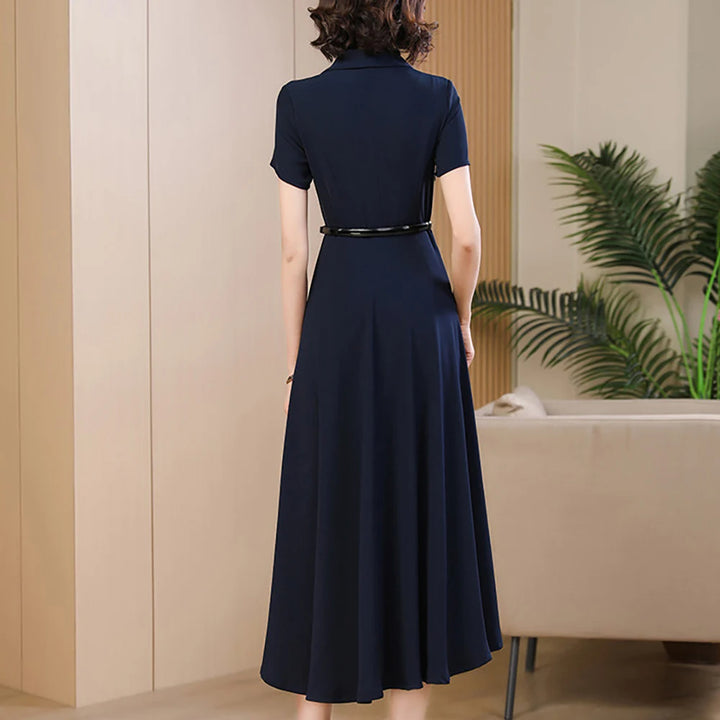 Back view of navy mid-calf A-line dress with short sleeves and waist belt