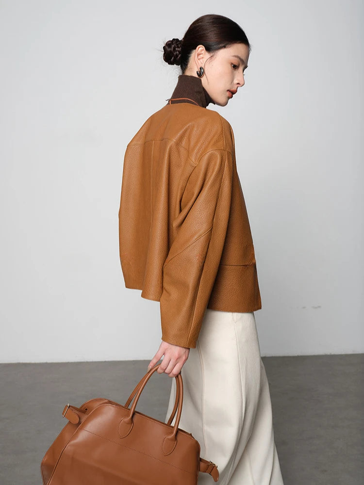 Ginger-brown leather short jacket from back view with relaxed shoulder and stand collar