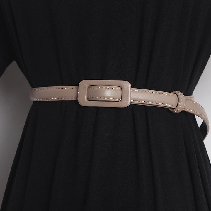Taupe narrow leather belt with rectangular buckle and stitched strap edges