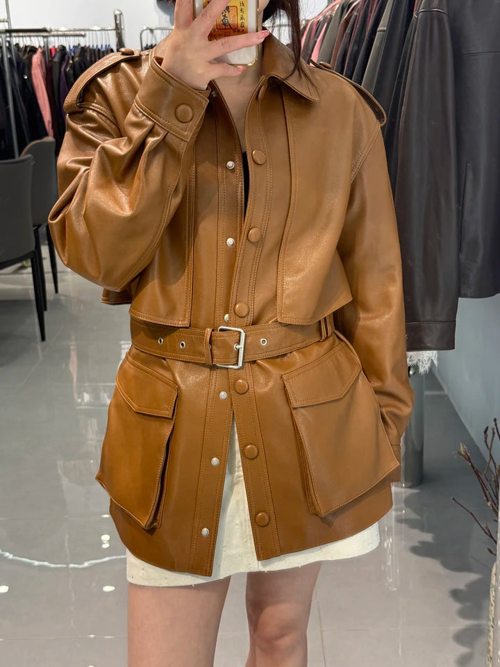 Belted tan-brown leather coat with point collar, snap buttons, and front waist belt