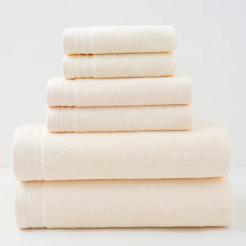 Cream cotton bath towel set, stacked rolled towels with solid terry texture