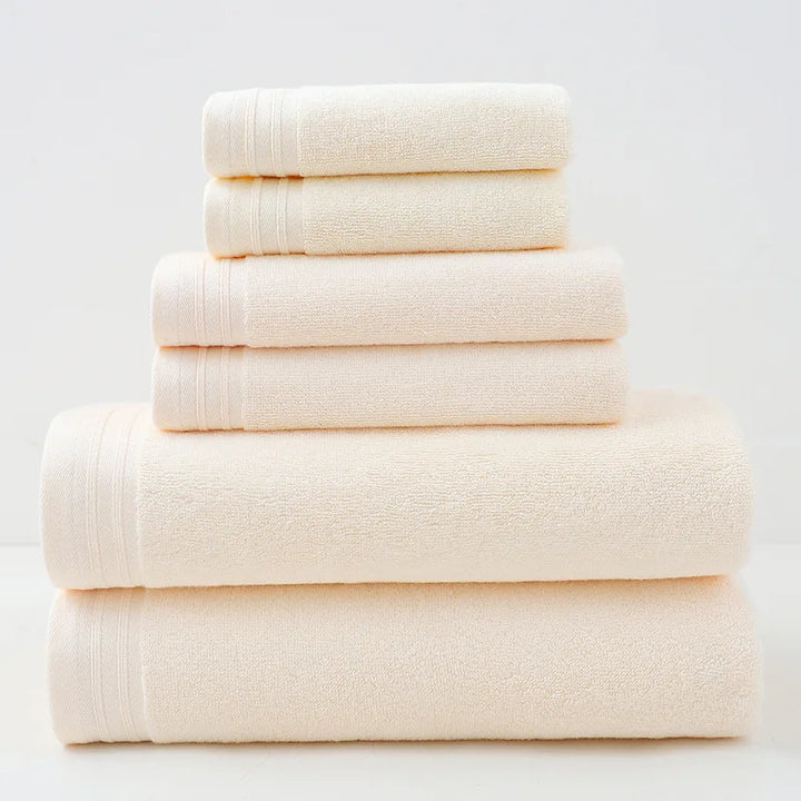 Cream cotton bath towel set, stacked rolled towels with solid terry texture