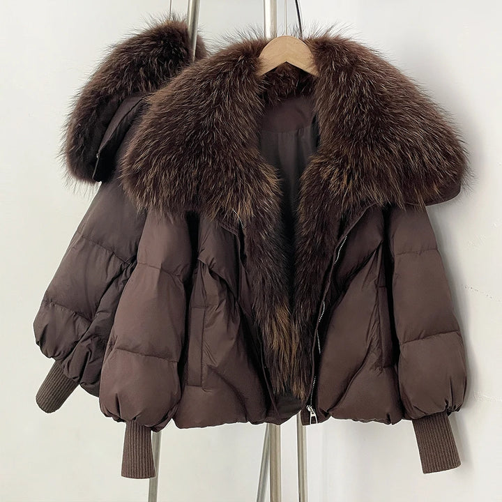Dark brown puffer coat with large dark faux-fur collar and front zip, rib-knit cuffs