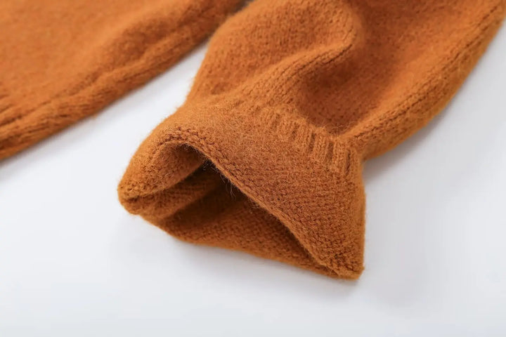 Orange cropped knit cardigan sleeve and hem close-up