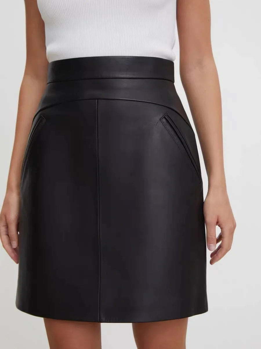 Black high-waist leather mini skirt with front panel seams and clean waistband
