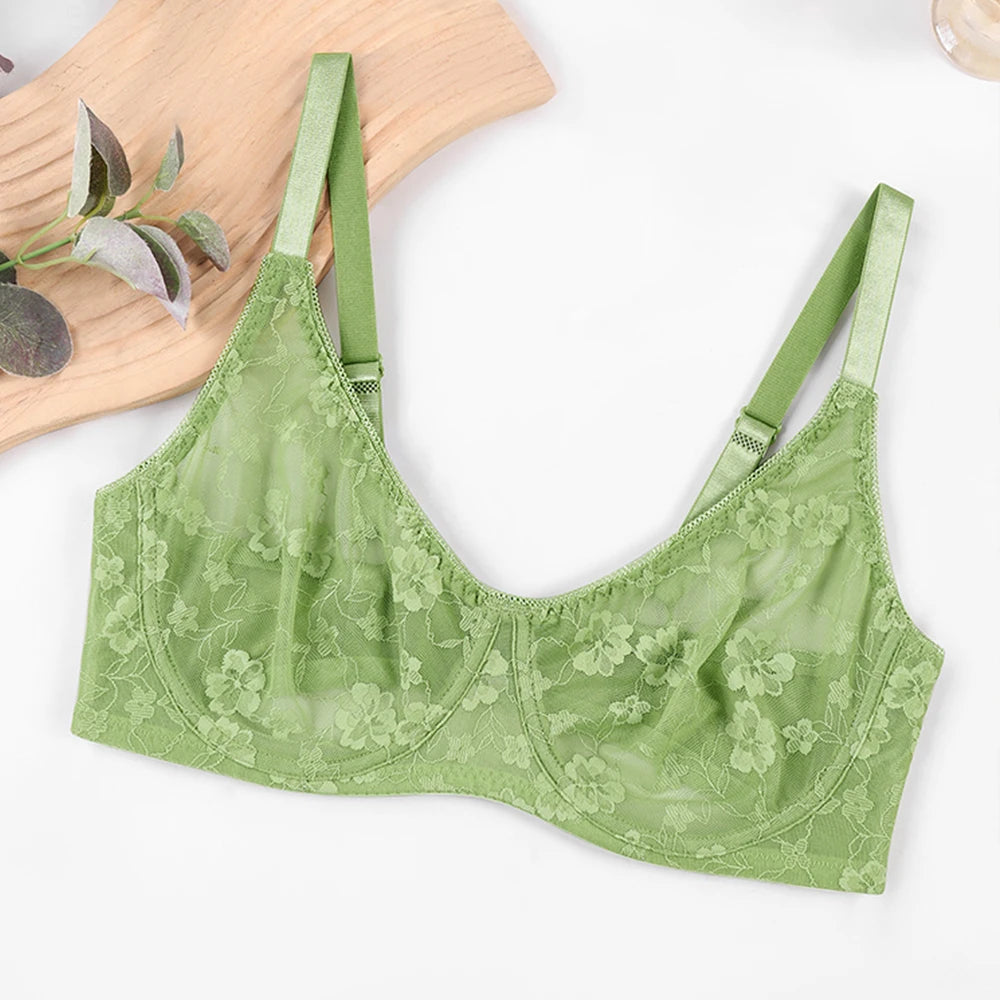 Green lace underwire bra laid flat with floral cups and adjustable straps