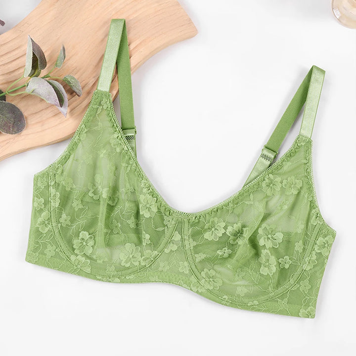 Green lace underwire bra laid flat with floral cups and adjustable straps